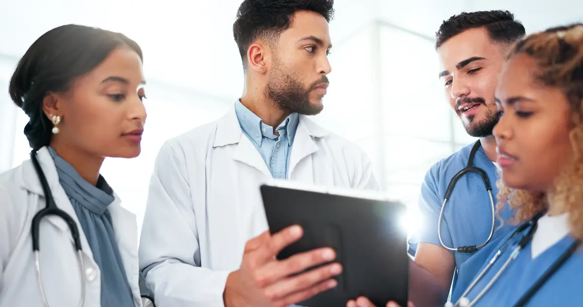 Doctor teamwork and tablet for healthcare research planning and collaboration with residency training Nurse and medical people on digital technology for clinic hospital or management software